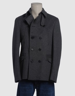 Woollen cloth - Four pockets - Button closing - Rear slit - Lined interior -
