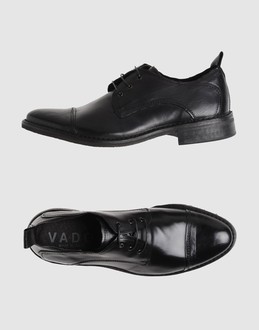 Polished leather - Laced closure - Leather sole - Stitch detailing - Aged-looking leather -